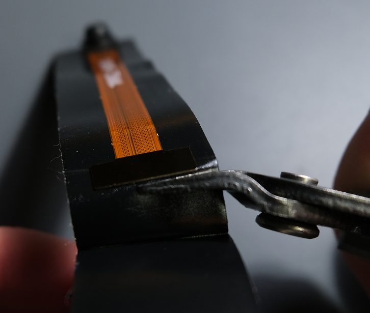 Be careful to not cut the camera connector in the process.