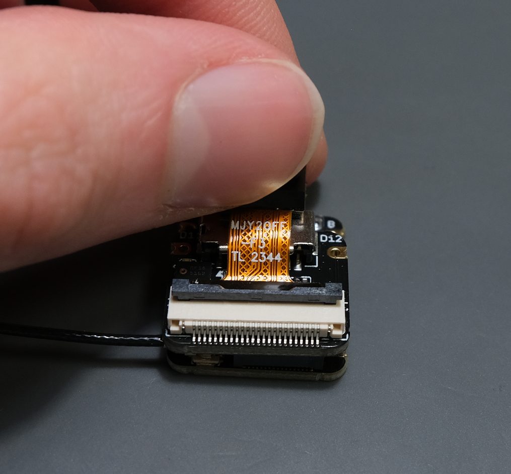 Now grab the camera and gently wiggle it out of the connector.