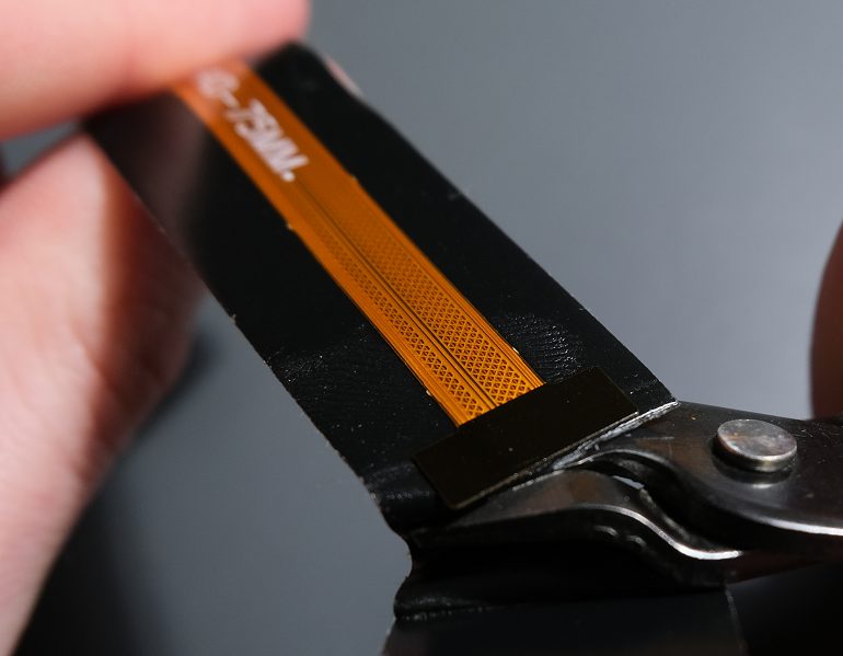 Be careful to not cut the camera connector in the process.